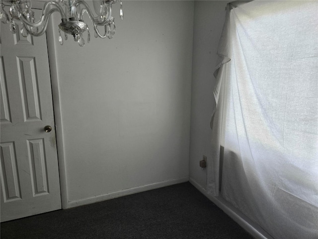 2308 18th St E, Bradenton, FL 34208 - unfurnished room featuring a chandelier and dark colored carpet
