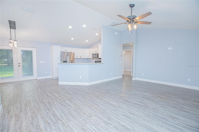 4911 NE 7th St, Ocala, FL 34470 - unfurnished living room featuring light wood finished floors, vaulted ceiling, ceiling fan, and recessed lighting