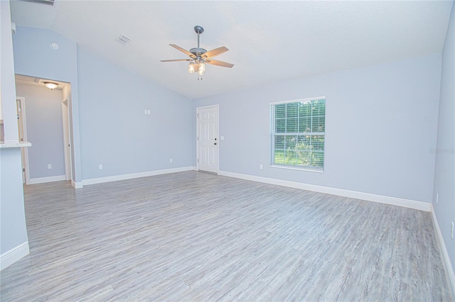 4911 NE 7th St, Ocala, FL 34470 - spare room with vaulted ceiling, ceiling fan, and light wood-style floors