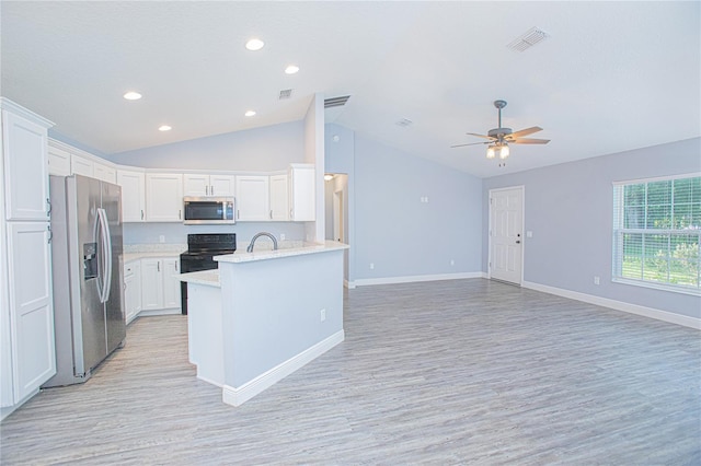 4911 NE 7th St, Ocala, FL 34470 - kitchen featuring appliances with stainless steel finishes, lofted ceiling, light wood-style flooring, white cabinetry, and a ceiling fan