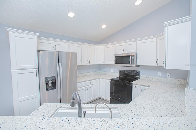 4911 NE 7th St, Ocala, FL 34470 - kitchen featuring stainless steel appliances, white cabinetry, light stone countertops, lofted ceiling, and recessed lighting