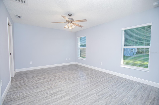 4911 NE 7th St, Ocala, FL 34470 - empty room with wood finished floors, ceiling fan, a textured ceiling, and a smoke detector