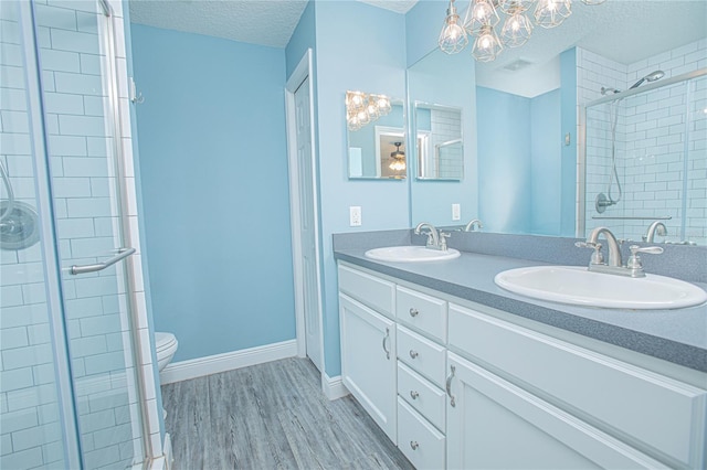 4911 NE 7th St, Ocala, FL 34470 - full bath featuring a shower stall, a chandelier, double vanity, and a textured ceiling