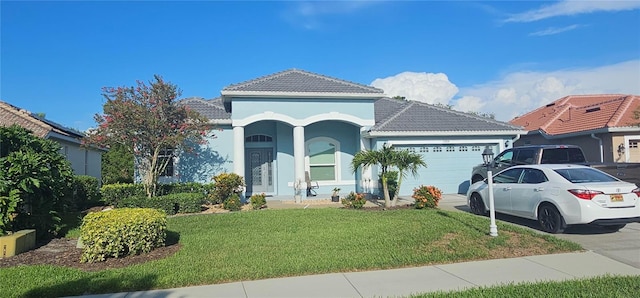 1884 Coconut Palm Cir, North Port, FL 34288 - view of front of property with a tiled roof, an attached garage, a front lawn, concrete driveway, and stucco siding