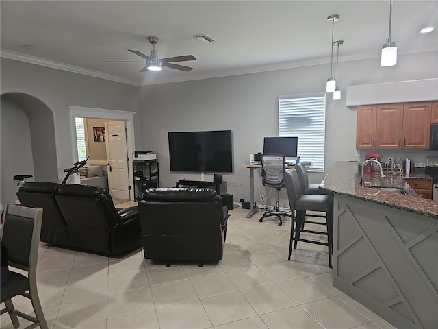 1884 Coconut Palm Cir, North Port, FL 34288 - living room with a ceiling fan, crown molding, plenty of natural light, and light tile patterned floors