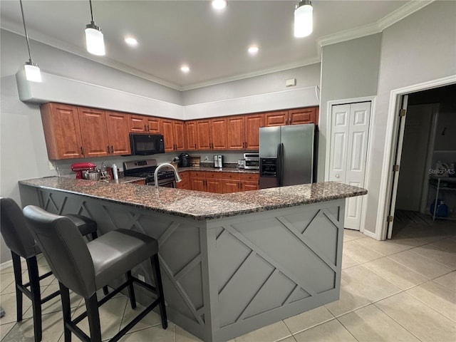 1884 Coconut Palm Cir, North Port, FL 34288 - kitchen with stainless steel appliances, crown molding, a peninsula, a kitchen breakfast bar, and dark stone countertops