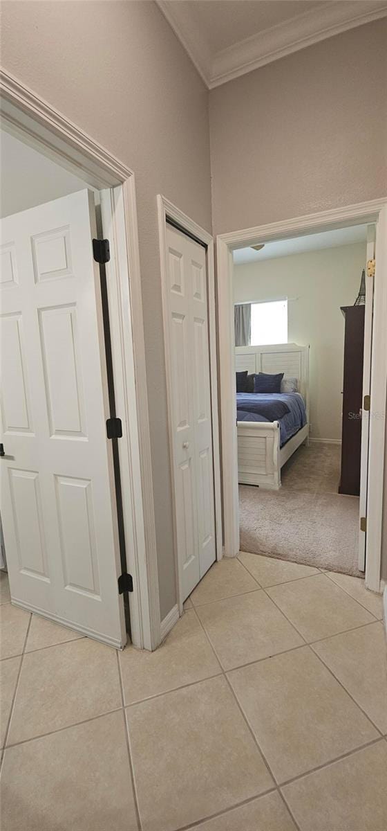 1884 Coconut Palm Cir, North Port, FL 34288 - hall featuring crown molding, light tile patterned floors, and light colored carpet