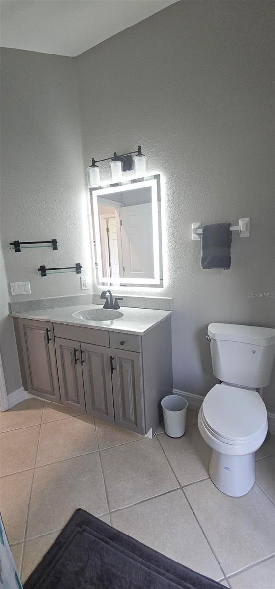 1884 Coconut Palm Cir, North Port, FL 34288 - bathroom with vanity and tile patterned flooring