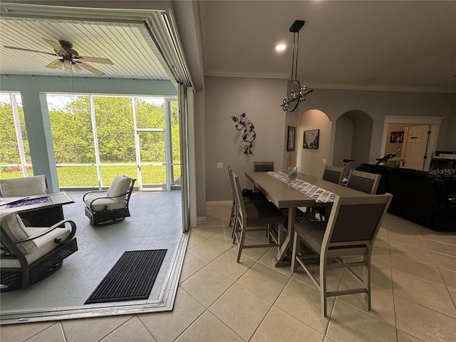 1884 Coconut Palm Cir, North Port, FL 34288 - dining room with light tile patterned floors, arched walkways, a ceiling fan, and ornamental molding