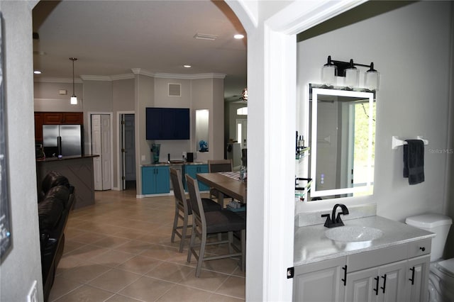 1884 Coconut Palm Cir, North Port, FL 34288 - bathroom with tile patterned floors, vanity, ornamental molding, and recessed lighting