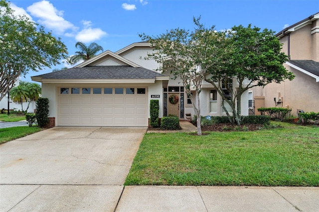 14558 Mandolin Dr, Orlando, FL 32837 - view of front of property featuring stucco siding, a front yard, a garage, and driveway