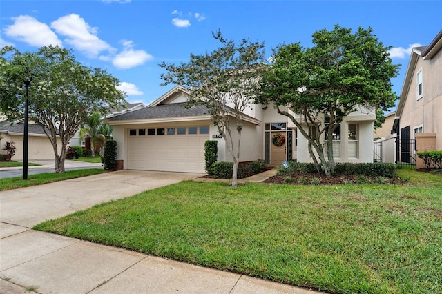 14558 Mandolin Dr, Orlando, FL 32837 - view of front of home with a garage, a front yard, stucco siding, and concrete driveway