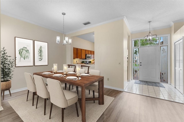 14558 Mandolin Dr, Orlando, FL 32837 - dining area with light wood finished floors, a chandelier, and ornamental molding
