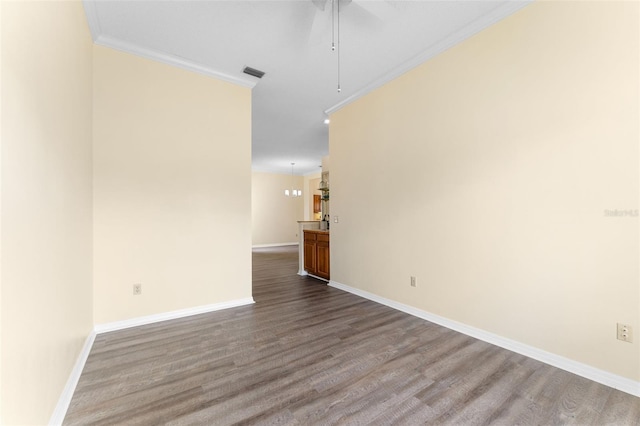 14558 Mandolin Dr, Orlando, FL 32837 - unfurnished room with crown molding, a ceiling fan, and dark wood-style floors