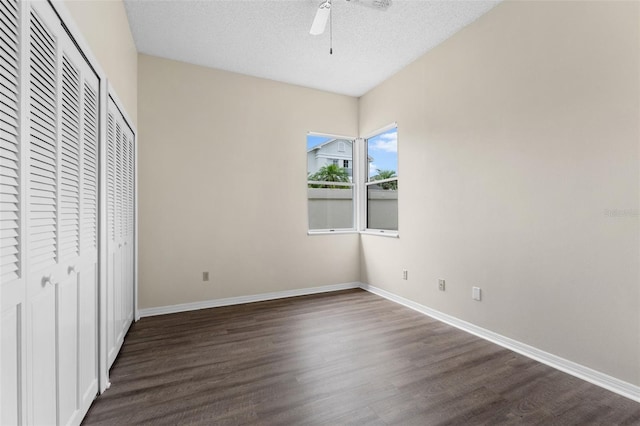 14558 Mandolin Dr, Orlando, FL 32837 - unfurnished bedroom featuring dark wood-type flooring, a closet, a textured ceiling, and ceiling fan