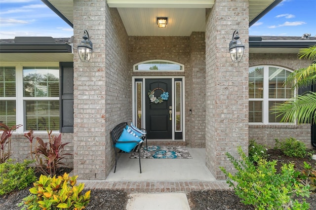 28 Noah Blvd, Flagler Beach, FL 32136 - view of exterior entry with brick siding and a porch