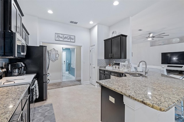 28 Noah Blvd, Flagler Beach, FL 32136 - kitchen featuring white range, stainless steel microwave, light stone countertops, a ceiling fan, and backsplash