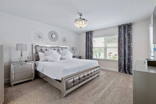 28 Noah Blvd, Flagler Beach, FL 32136 - bedroom with light carpet, a textured ceiling, and a chandelier