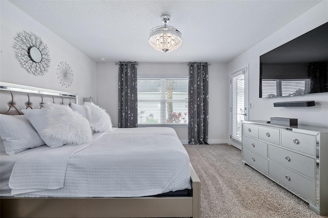 28 Noah Blvd, Flagler Beach, FL 32136 - bedroom featuring a chandelier, light colored carpet, and a textured ceiling