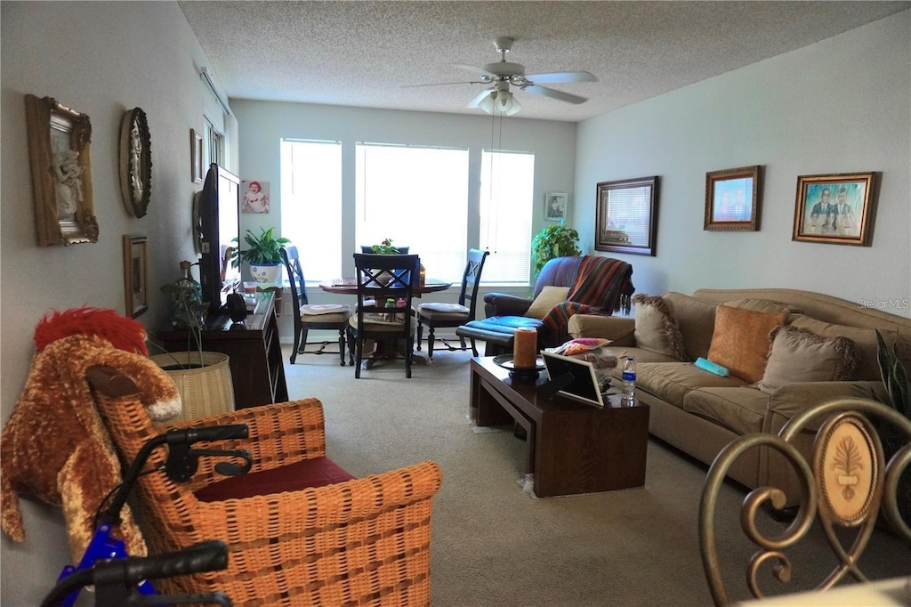 1031 S Hiawassee Rd Unit 2514, Orlando, FL 32835 - living area featuring carpet flooring, ceiling fan, and a textured ceiling