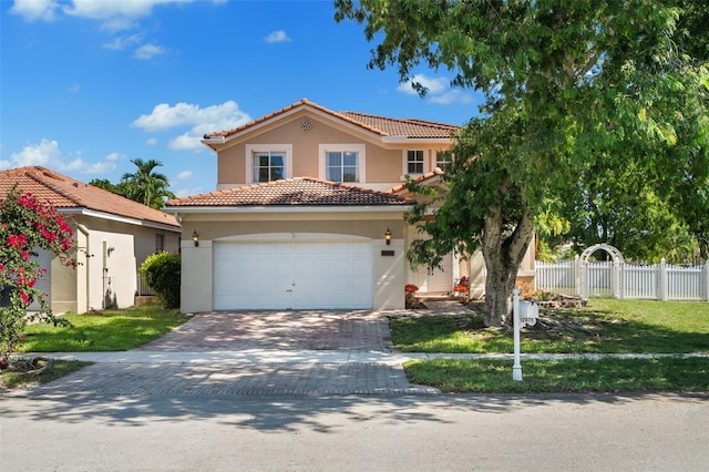 12978 SW 26th St, Miramar, FL 33027 - mediterranean / spanish home featuring stucco siding, a tiled roof, driveway, and a garage