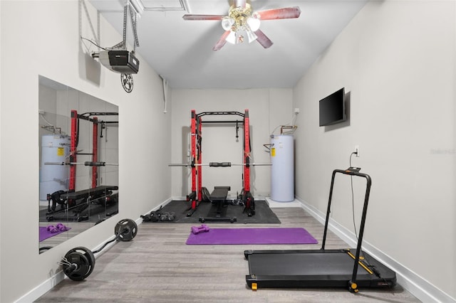 12978 SW 26th St, Miramar, FL 33027 - workout room featuring water heater, secured water heater, ceiling fan, and wood finished floors