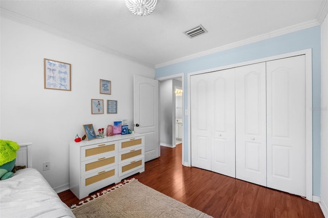 12978 SW 26th St, Miramar, FL 33027 - bedroom with crown molding, wood finished floors, and a closet