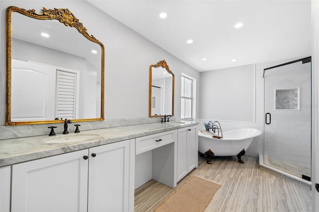 12978 SW 26th St, Miramar, FL 33027 - full bathroom featuring a freestanding tub, double vanity, a shower stall, wood finished floors, and recessed lighting
