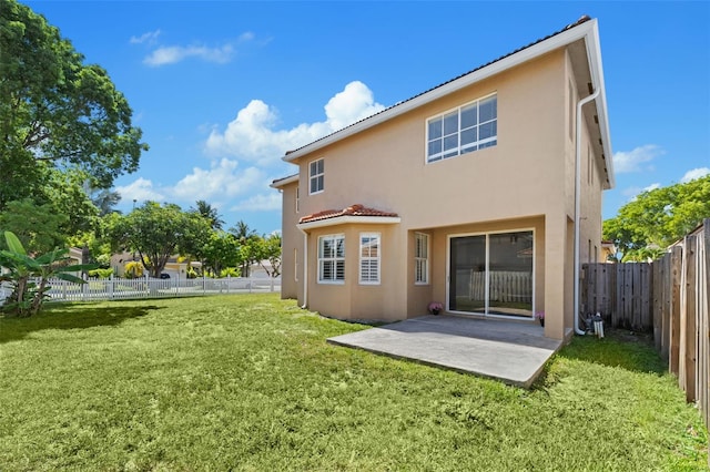12978 SW 26th St, Miramar, FL 33027 - rear view of property featuring stucco siding, a patio, a fenced backyard, and a tiled roof