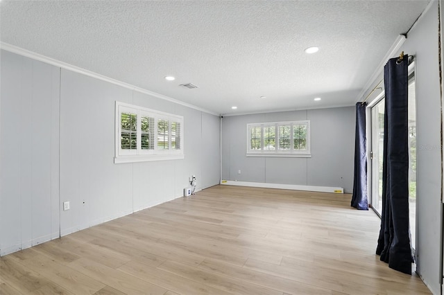 4611 Cranston Pl, Orlando, FL 32812 - spare room with crown molding, a textured ceiling, light wood-style floors, and a decorative wall