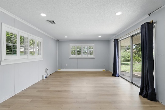 4611 Cranston Pl, Orlando, FL 32812 - empty room with ornamental molding, a textured ceiling, light wood finished floors, recessed lighting, and a decorative wall