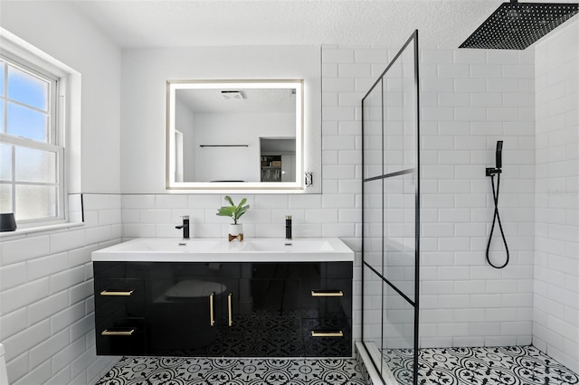 4611 Cranston Pl, Orlando, FL 32812 - bathroom featuring tile walls, a stall shower, double vanity, and a textured ceiling