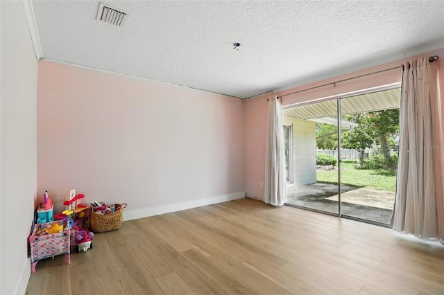 4611 Cranston Pl, Orlando, FL 32812 - spare room featuring wood finished floors and a textured ceiling