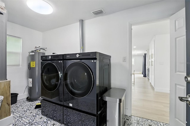 4611 Cranston Pl, Orlando, FL 32812 - laundry room with water heater and independent washer and dryer