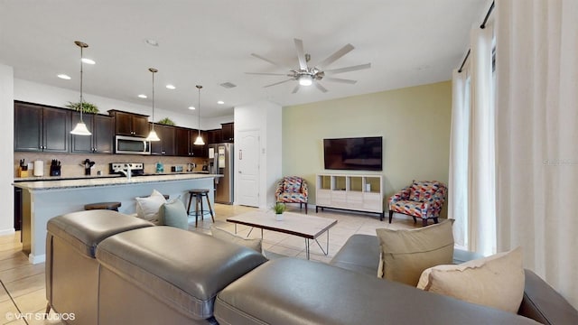 8806 Geneve Ct, Kissimmee, FL 34747 - living room with light tile patterned floors, a ceiling fan, and recessed lighting