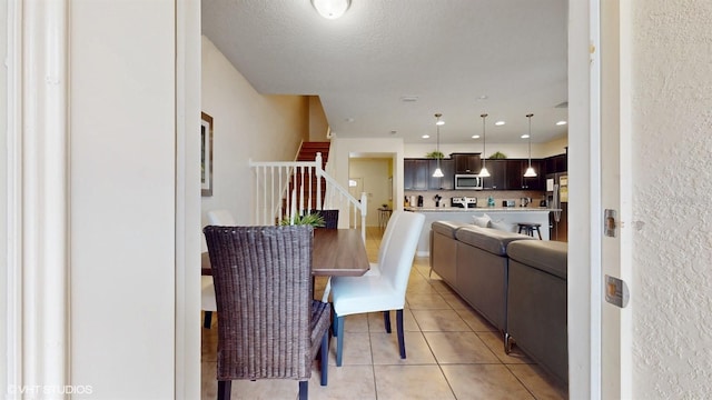 8806 Geneve Ct, Kissimmee, FL 34747 - dining space featuring light tile patterned floors and stairs