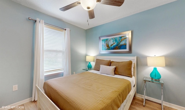 8806 Geneve Ct, Kissimmee, FL 34747 - bedroom with wood finished floors, multiple windows, and ceiling fan