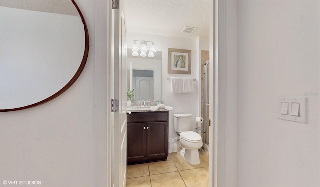 8806 Geneve Ct, Kissimmee, FL 34747 - bathroom with vanity, a textured ceiling, a shower with shower door, tile patterned floors, and a chandelier