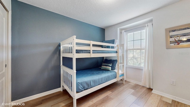 8806 Geneve Ct, Kissimmee, FL 34747 - bedroom with wood finished floors and a textured ceiling