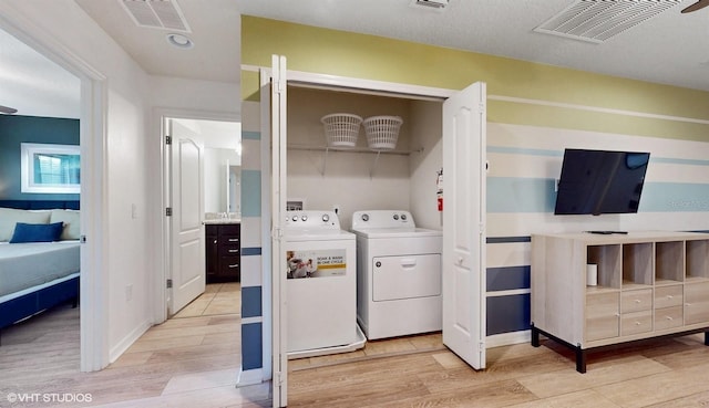8806 Geneve Ct, Kissimmee, FL 34747 - laundry area featuring separate washer and dryer and light wood-type flooring
