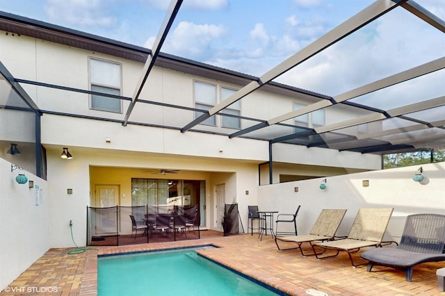 8806 Geneve Ct, Kissimmee, FL 34747 - swimming pool featuring a patio, glass enclosure, and outdoor dining space