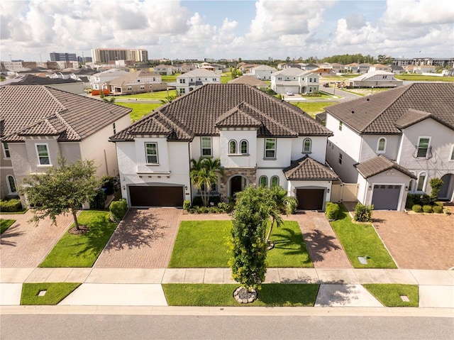 8066 Ludington Cir, Orlando, FL 32836 - mediterranean / spanish home featuring a residential view, decorative driveway, stucco siding, a tile roof, and a front yard