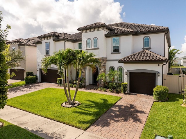 8066 Ludington Cir, Orlando, FL 32836 - mediterranean / spanish home featuring decorative driveway, a tile roof, an attached garage, and stucco siding