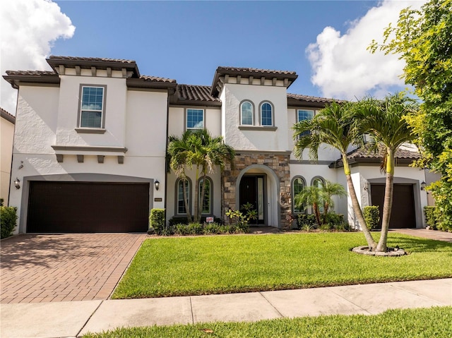 8066 Ludington Cir, Orlando, FL 32836 - mediterranean / spanish home with decorative driveway, an attached garage, stucco siding, and a front lawn