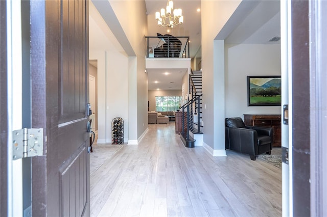 8066 Ludington Cir, Orlando, FL 32836 - entrance foyer with a chandelier, light wood-type flooring, stairway, and a towering ceiling