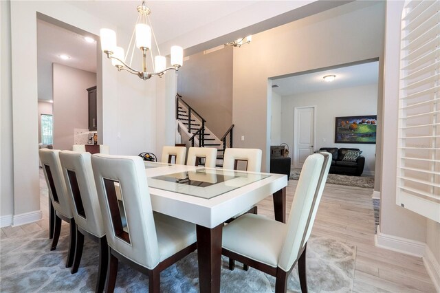 8066 Ludington Cir, Orlando, FL 32836 - dining area featuring a chandelier, stairs, light wood-style floors, and recessed lighting