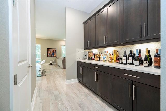 8066 Ludington Cir, Orlando, FL 32836 - indoor dry bar featuring decorative backsplash and light wood-style flooring