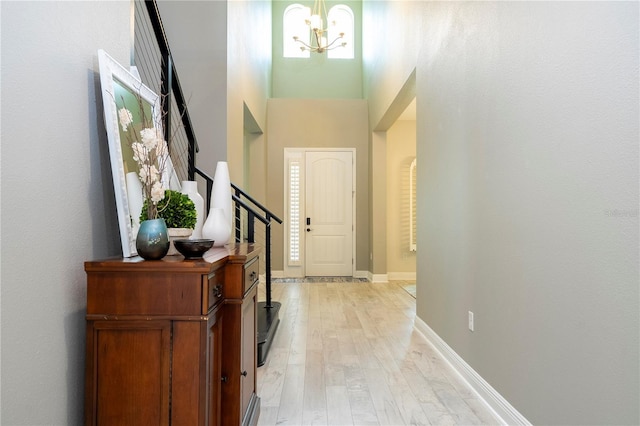8066 Ludington Cir, Orlando, FL 32836 - foyer with a chandelier, light wood-type flooring, a high ceiling, and stairway