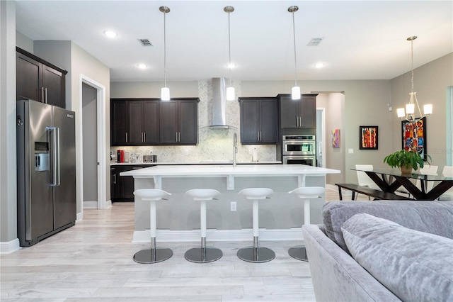 8066 Ludington Cir, Orlando, FL 32836 - kitchen with appliances with stainless steel finishes, wall chimney exhaust hood, open floor plan, a kitchen breakfast bar, and recessed lighting