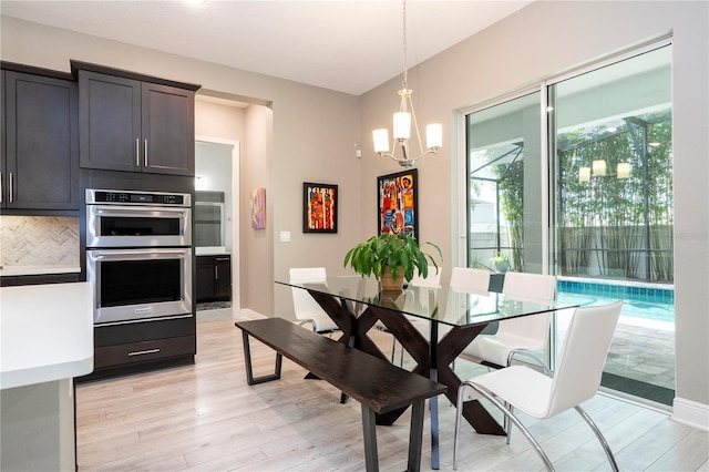 8066 Ludington Cir, Orlando, FL 32836 - dining room with light wood-style floors and a chandelier